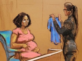 Jerhonda Pace is shown a shirt that she had worn, as singer R. Kelly attends Brooklyn's Federal District Court during the start of his trial in New York, U.S., August 18, 2021 in a courtroom sketch.