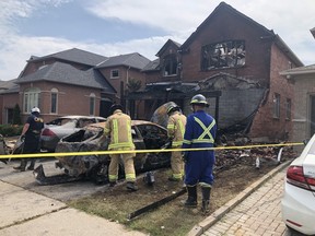One day after a car was deliberately crashed into the garage of a house on Secord St. in Pickering and set ablaze, engulfing the home in flames, Ontario fire marshals investigate on Wednesday, Aug. 25, 2021.