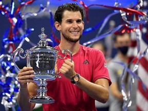 Sep 13 2020; Flushing Meadows, New York, USA; Dominic Thiem of Austria celebrates with the championship trophy after his match against Alexander Zverev of Germany (not pictured) in the men's singles final match on day fourteen of the 2020 U.S. Open tennis tournament at USTA Billie Jean King National Tennis Center.
