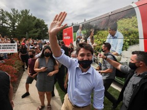 Canada's Liberal Prime Minister Justin Trudeau waves during his election campaign tour in Nobleton, Ont. on Aug. 27, 2021.