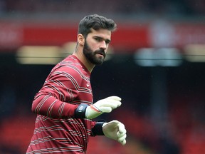 Liverpool's Brazilian goalkeeper Alisson Becker warms up ahead of the English Premier League football match between Liverpool and Burnley.