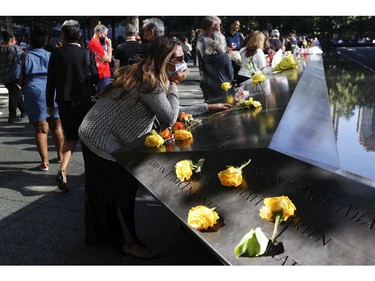 A woman mourns at the 9/11 Memorial during a ceremony at the National September 11 Memorial & Museum commemorating the 20th anniversary of the September 11th terrorist attacks on the World Trade Center on Sept. 11, 2021 in New York City.