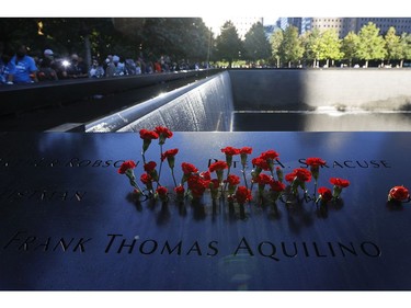Flowers are seen on the 9/11 Memorial during a ceremony at the National September 11 Memorial & Museum commemorating the 20th anniversary of the September 11th terrorist attacks on the World Trade Center on Sept. 11, 2021 in New York City.