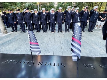 Firefighters from FDNY Engine Company 217, Brooklyn, salute near the name of their fallen colleagues during a ceremony at the National September 11 Memorial & Museum commemorating the 20th anniversary of the September 11th terrorist attacks on the World Trade Center on Sept. 11, 2021 in New York City.