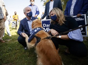 Erin O’Toole, leader of the Conservative Party of Canada, and his wife Rebecca O’Toole, greet a dog as they leave a campaign stop on September 18, 2021 in Dundas, Ontario, Canada.