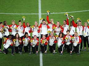 Canada pose with their gold medals after the Women's Football Medal Ceremony at the Tokyo 2020 Olympic Games.