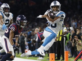 Panthers running back Chuba Hubbard gets pushed out of bounds against the Texans on Thursday.