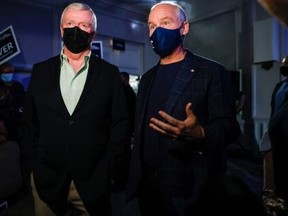 Conservative Leader Erin O'Toole (right) speaks with retired general Rick Hillier, former chief of defence staff, while campaigning in  Kitchener on Sept. 18, 2021.