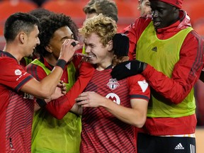 Toronto FC midfielder Marco Delgado (left) celebrates his second-half goal against FC Cincinnati on Wednesday night.