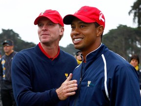 Steve Stricker and Tiger Woods of the USA Team celebrate after the USA defeated the International Team 19.5 to 14.5 to win   The Presidents Cup at Harding Park Golf Course on October 11, 2009 in San Francisco, California.