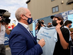 Conservative Party leader Erin O'Toole signs a t-shirt for James Knight of West Vancouver, that reads Future Prime Minister at an election campaign visit to North Vancouver, British Columbia, Canada September 3, 2021.