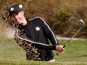 Team Europe's Rory McIlroy hits out of a bunkder during practice at the Ryder Cup on Thursday. REUTERS/