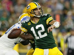 Green Bay Packers quarterback Aaron Rodgers (12) throws a pass against the Detroit Lions during the third quarter at Lambeau Field.
