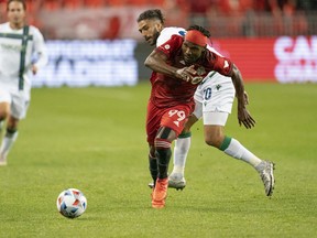 Toronto FC forward Ifunanyachi Achara (99) battles for the ball with York United defender Diyaeddine Abzi during the first half in the quarterfinal of the Canadian Championship at BMO Field on Wednesday night.