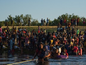 Haitian migrants cross across the U.S.-Mexico border on the Rio Grande as seen from Ciudad Acuna, Coahuila state, Mexico on September 20, 2021.