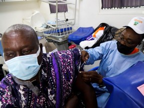 An Ivorian traditional chief receives a vaccine against COVID-19 at a mobile vaccination centRe in Abidjan, Ivory Coast Sept. 23, 2021.