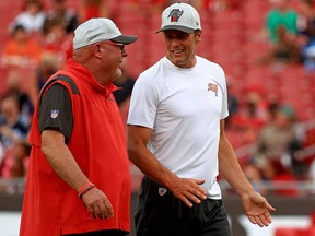 Head coach Bruce Arians and Tom Brady of the Tampa Bay Buccaneers talk during a preseason game against the Tennessee Titans at Raymond James Stadium on August 21, 2021 in Tampa, Florida.
