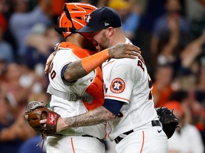 Martin Maldonado of the Houston Astros and Ryan Pressly celebrate after defeating the Tampa Bay Rays at Minute Maid Park on Sept. 30, 2021 in Houston, Texas.