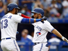 Breyvic Valera of the Blue Jays celebrates with Lourdes Gurriel Jr. after hitting a home run against the Oakland Athletics at Rogers Centre on September 4, 2021 in Toronto.