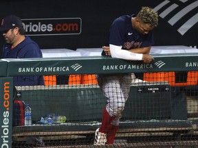 Xander Bogaerts of the Boston Red Sox looks  on from the dugout following the Red Sox 6-2 loss to the Baltimore Orioles at Oriole Park at Camden Yards on Sept. 30, 2021 in Baltimore.