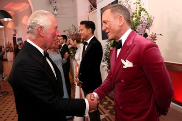 Britain's Prince Charles speaks with actor Daniel Craig at the world premiere of the new James Bond film "No Time To Die" at the Royal Albert Hall in London, England, Tuesday, Sept. 28, 2021.