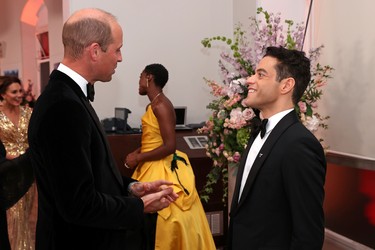 Britain's Prince William, Duke of Cambridge, speaks with actor Rami Malek at the world premiere of the new James Bond film "No Time To Die" at the Royal Albert Hall in London, England, Tuesday, Sept. 28, 2021.