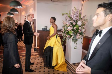 Britain's Prince William, Duke of Cambridge (left) talks with English actor Lashana Lynch ahead of the World Premiere of the James Bond 007 film "No Time to Die" at the Royal Albert Hall in London, England, Tuesday, Sept. 28, 2021.