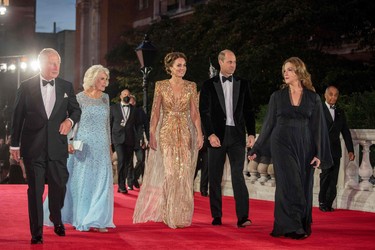 From left to right, Britain's Prince Charles, Prince of Wales, Britain's Camilla, Duchess of Cornwall, Britain's Catherine, Duchess of Cambridge and U.S.-British film producer Barbara Broccoli  arrive ahead of the World Premiere of the James Bond 007 film "No Time to Die" at the Royal Albert Hall in London, England, Tuesday, Sept. 28, 2021.