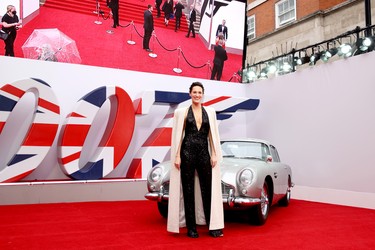 Phoebe Waller-Bridge stands next to James Bonds Aston Martin at the World Premiere of "No Time To Die" at the Royal Albert Hall in London, England, Tuesday, Sept. 28, 2021.