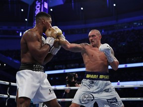 Boxing - WBA, IBF & WBO Heavyweight Titles - Anthony Joshua v Oleksandr Usyk - Tottenham Hotspur Stadium, London, Britain - September 25, 2021 Anthony Joshua in action against Oleksandr Usyk.