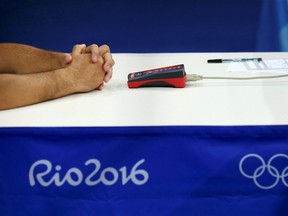 The hands of a boxing official are seen during a bout at the 2016 Summer Games in Rio de Janeiro, Brazil, Aug. 17, 2016.