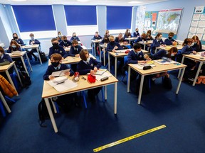 Students attend a lesson at Weaverham High School, as the COVID-19 lockdown begins to ease, in Cheshire, Britain, March 9, 2021.