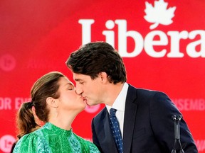 Canada's Liberal Prime Minister Justin Trudeau kisses his wife Sophie Gregoire during the Liberal election night party in Montreal September 21, 2021.