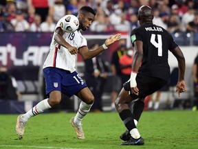 United States midfielder Brenden Aaronson (11) plays the ball off his shoulder against Canada defender Kamal Miller (4) during their CONCACAF World Cup Qualifier at Nissan Stadium.