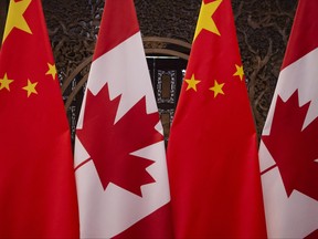 In this file photo taken on Dec. 5, 2017, shows Canadian and Chinese flags taken prior to a meeting with Prime Minister Justin Trudeau and China's President Xi Jinping at the Diaoyutai State Guesthouse in Beijing.
