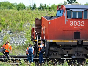 In this file photo, Canadian National Railway workers board a train during a recent shift change on the CN Rail main line just east of Belleville's historic railway yard along Airport Road in Belleville, Ont.