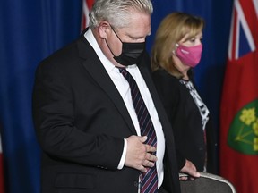Ontario Premier Doug Ford, left, and Christine Elliott Ontario Minister of Health arrive as they holds a press conference at Queen's Park during the COVID-19 pandemic in Toronto May 20, 2021.