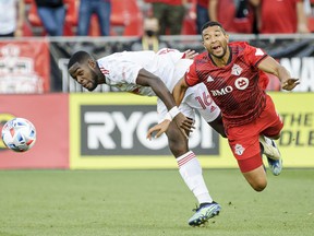 Toronto FC defender Justin Morrow (2) and New York Red Bulls midfielder Dru Yearwood (16) battle for the ball during first half MLS soccer action in Toronto, on Wednesday, July 21, 2021.