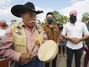 NDP leader Jagmeet Singh and local candidate Blake Desjarlais listen to elder Tom Durocher during a campaign rally in Edmonton, on Thursday, August 19, 2021.