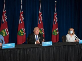 Ontario Premier Doug Ford, second left, responds to a question as Dr. Kieran Moore, Chief Medical Officer of Health, and 
Christine Elliott, Deputy Premier and Minister of Health,    listen, during a press conference at Queen's Park in Toronto  on Wednesday, September 1, 2021.