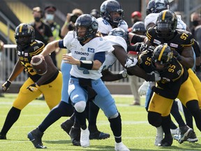 Argonauts quarterback McLeod Bethel-Thompson scrambles under pressure by the  Tiger Cats defence during their Labour Day Classic in Hamilton, Ont., Monday, Sept. 6, 2021.