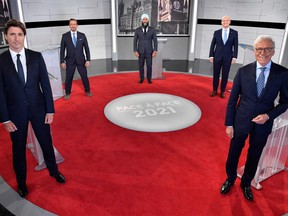 Prime Minister and leader of the Liberal Party Justin Trudeau, Bloc Quebecois leader Yves-Francois Blanchet, NDP leader Jagmeet Singh, Conservative leader Erin O'Toole and Canadian journalist Pierre Bruneau pose for the official photo at the TVA studios ahead of the Face-a-Face 2021 debate in Montreal, Sept. 2, 2021.