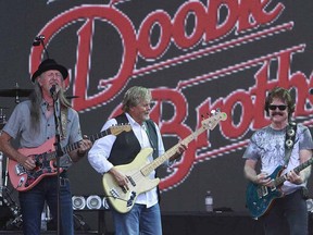 Patrick Simmons, John Cowan and Tom Johnston from the Doobie Brothers perform at the Stampede Roundup at Fort Calgary in Calgary, Alta. on Wednesday July 9, 2014.
