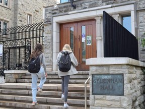 Western University students walk into the main door of Medway-Sydenham Residence Monday. (CALVI LEON, The London Free Press)
