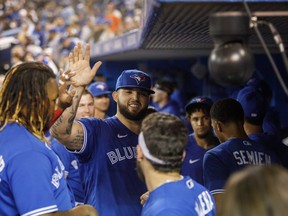 Blue Jays starter Alek Manoah celebrates in the dugout during the eighth inning against the Tampa Bay Rays at Rogers Centre on Monday, Sept. 13, 2021.