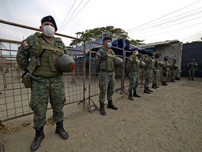 Soldiers stand guard outside the Guayas 1 prison in Guayaquil, Ecuador, on September 30, 2021.
