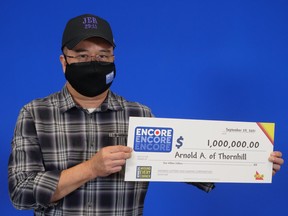 Arnold Agulto of Thornhill with his $1 million winnings from playing Encore.
