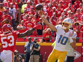 Los Angeles Chargers quarterback Justin Herbert (10) throws a pass as Kansas City Chiefs inside linebacker Anthony Hitchens (53) defends during the second half at GEHA Field at Arrowhead Stadium Sept. 26, 2021.