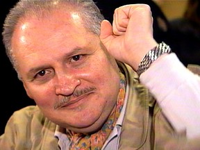 Ilich Ramirez Sanchez, better known as "Carlos the Jackal", raises his fist as he appears in court in Paris November 28, 2000 coinciding with a trial in Frankfurt of his former German accomplice [Hans-Joachim Klein].