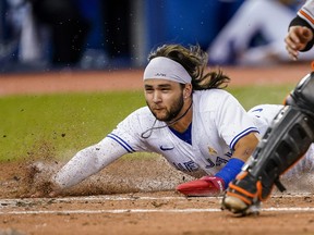 Blue Jays shortstop Bo Bichette slides into home plate to score against the Baltimore Orioles during the fourth inning at Rogers Centre on Wednesday, Sept. 1, 2021.